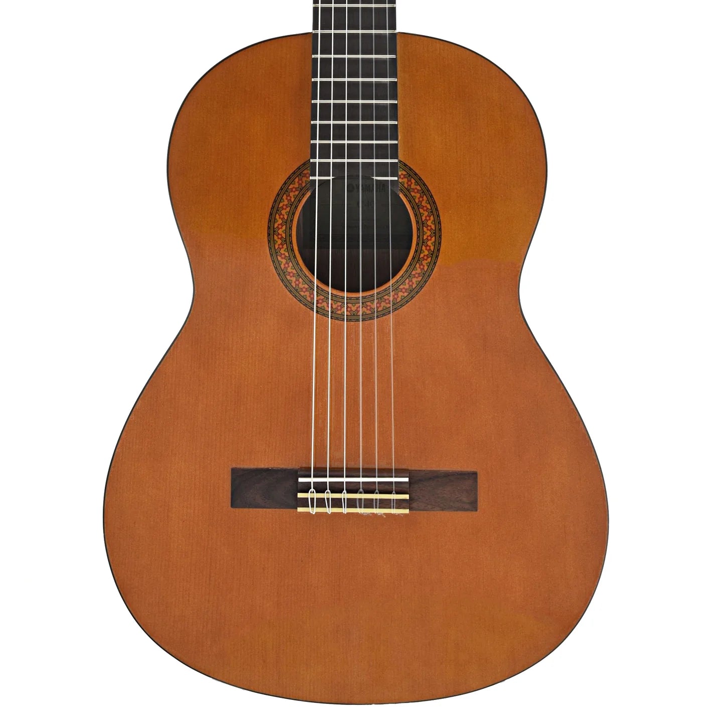 A classical acoustic guitar with a warm natural wood finish, shown from a top-down view against a solid white background. ALFAN ALRAQI