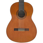 A classical acoustic guitar with a warm natural wood finish, shown from a top-down view against a solid white background. ALFAN ALRAQI