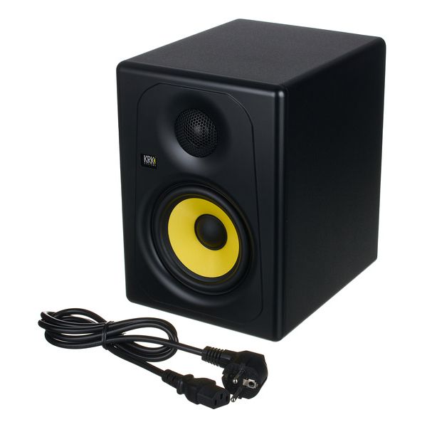 Black studio monitor speaker with yellow cone and power cable on a white background