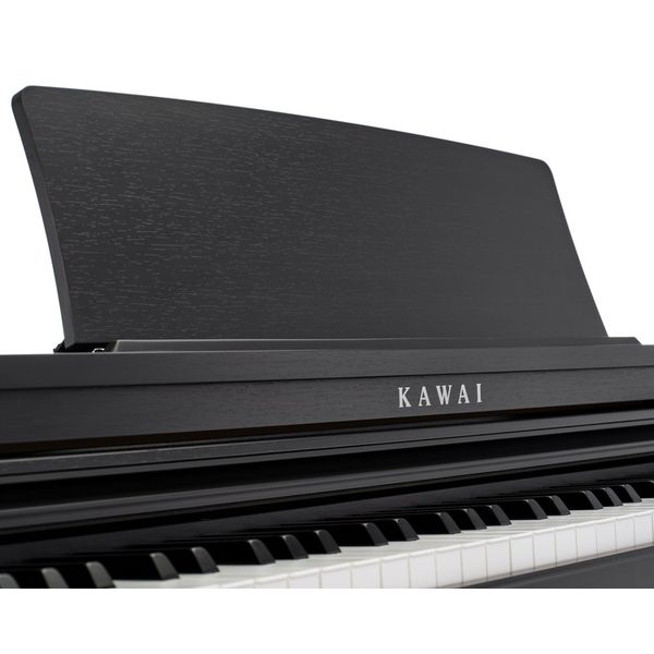 Black Kawai digital piano on a white background