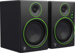 Pair of black speakers with green accents on a white background