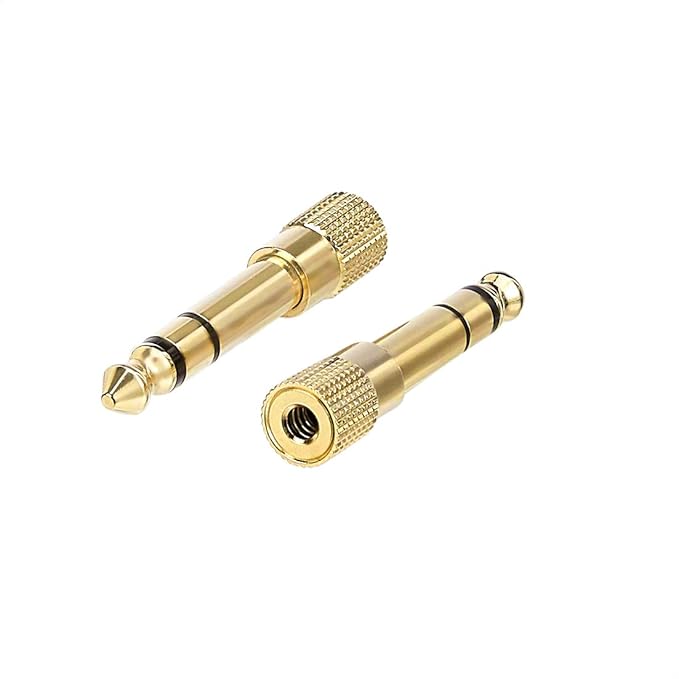 Two gold audio connectors on a white background
