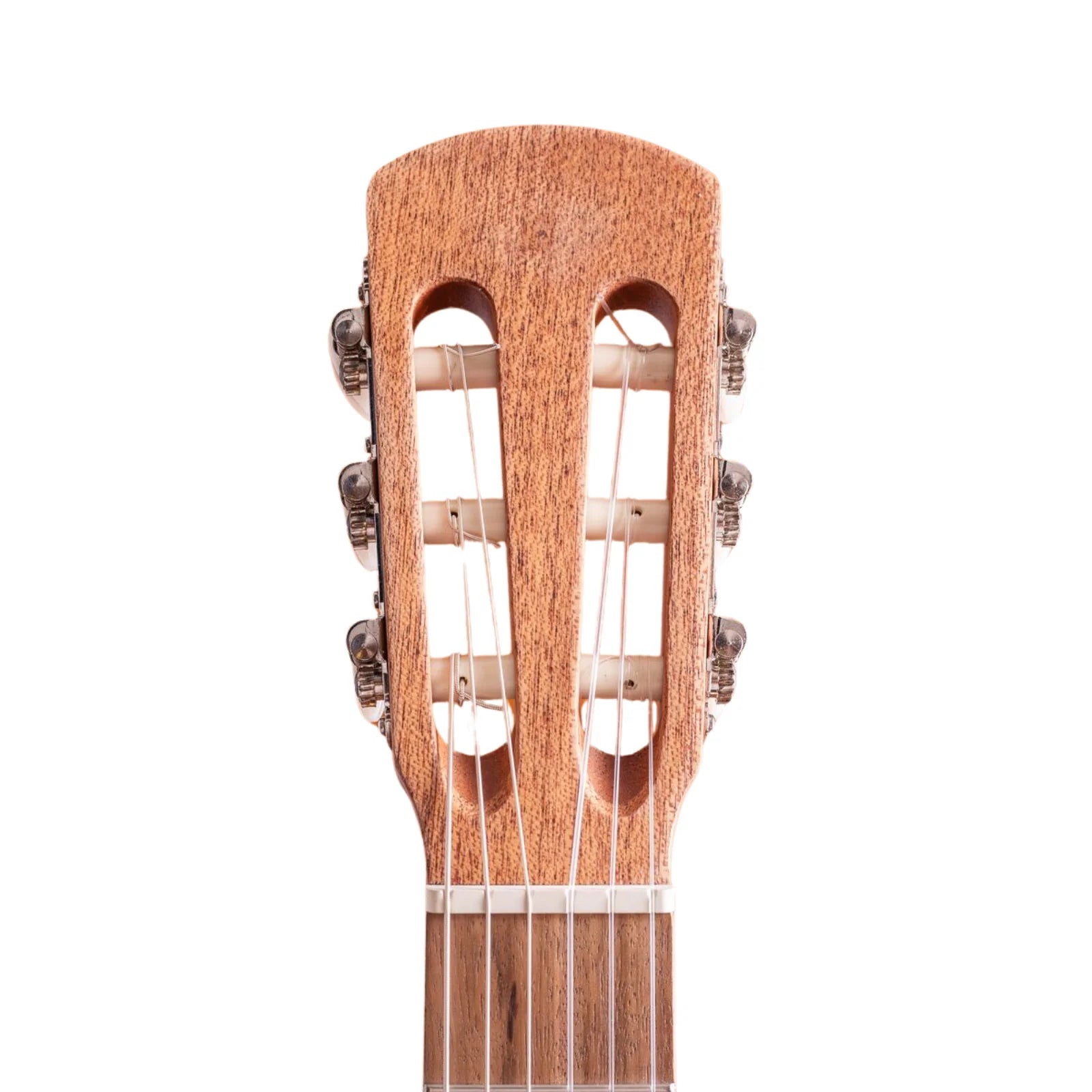 Close-up of a guitar's wooden soundboard with strings on a white background