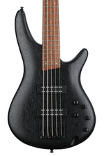 Black electric bass guitar with a wooden fretboard on a white background