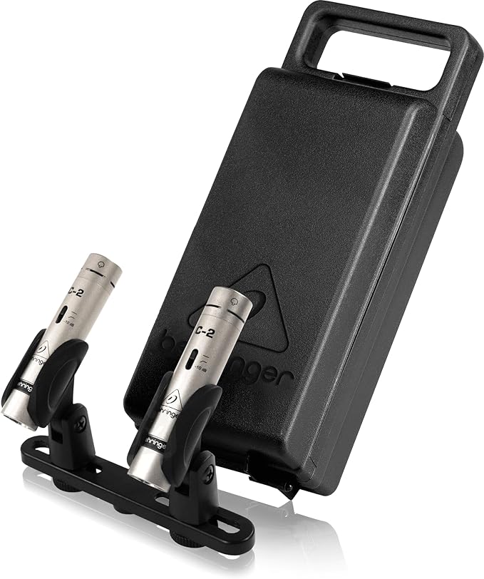 Two metal devices on a stand with a black carrying case featuring a logo.