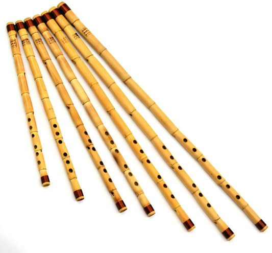 A set of seven traditional bamboo flute instruments arranged diagonally on a plain white background.