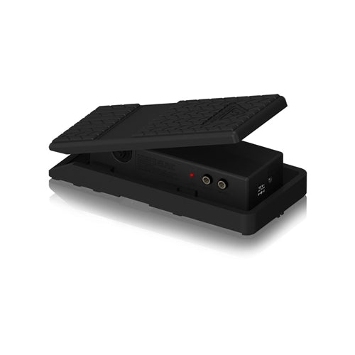 Black foot pedal with textured surface on a white background