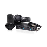 Audio recording setup with microphone, headphones, and audio interface on a white background