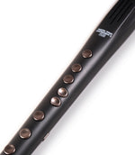 Black flute with brown buttons on a white background