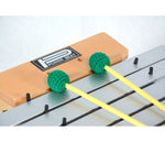Wooden drumming practice pad with green foam drumsticks on a white background