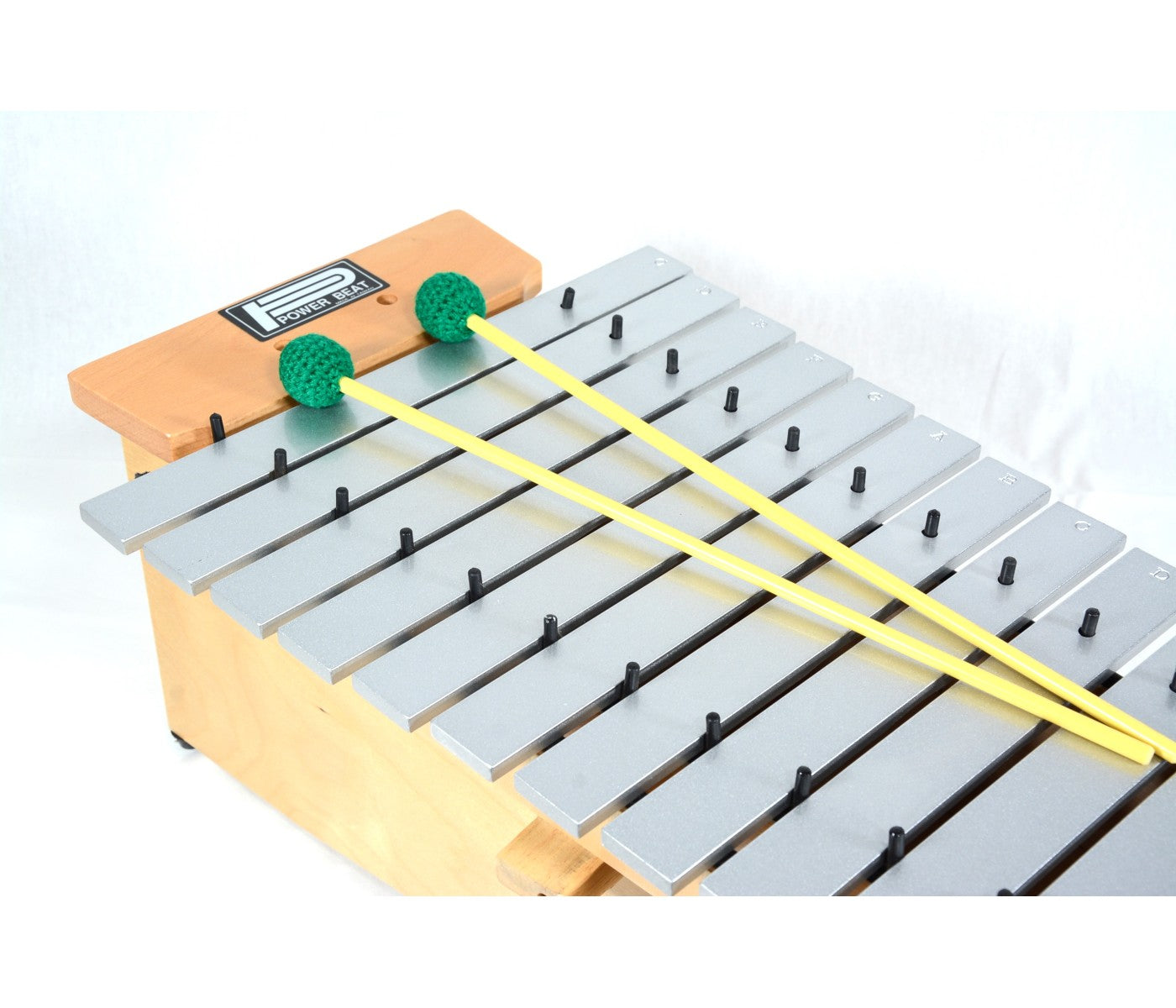 Metallophone with wooden base and metal bars on a white background