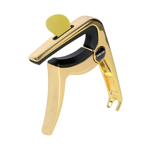 Gold guitar capo on a white background