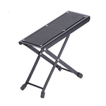 Black metal footstool with mesh surface on a white background