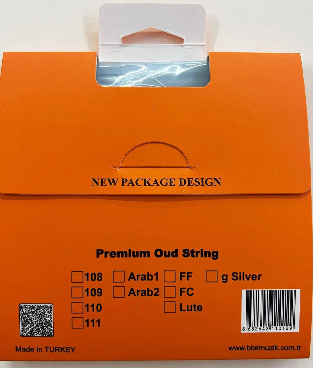 Orange product packaging for 'Premium Oud String' with a white hanging tab, featuring text details and barcode on a white background.