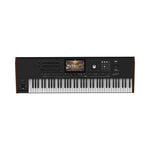 A Casio PX-5000 digital piano shown from the front against a plain white background. The keyboard has black and white keys, a black control panel with a small display screen, and dark brown wood-grain side panels.