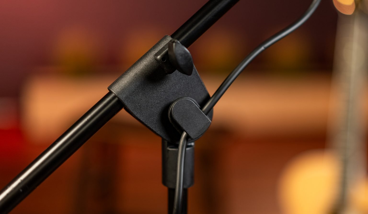 Close-up of a microphone stand with a blurred background