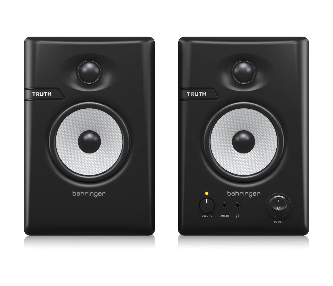 Pair of Behringer Truth studio monitors on a white background