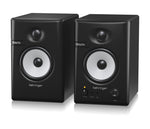 Pair of Behringer studio monitors on a white background