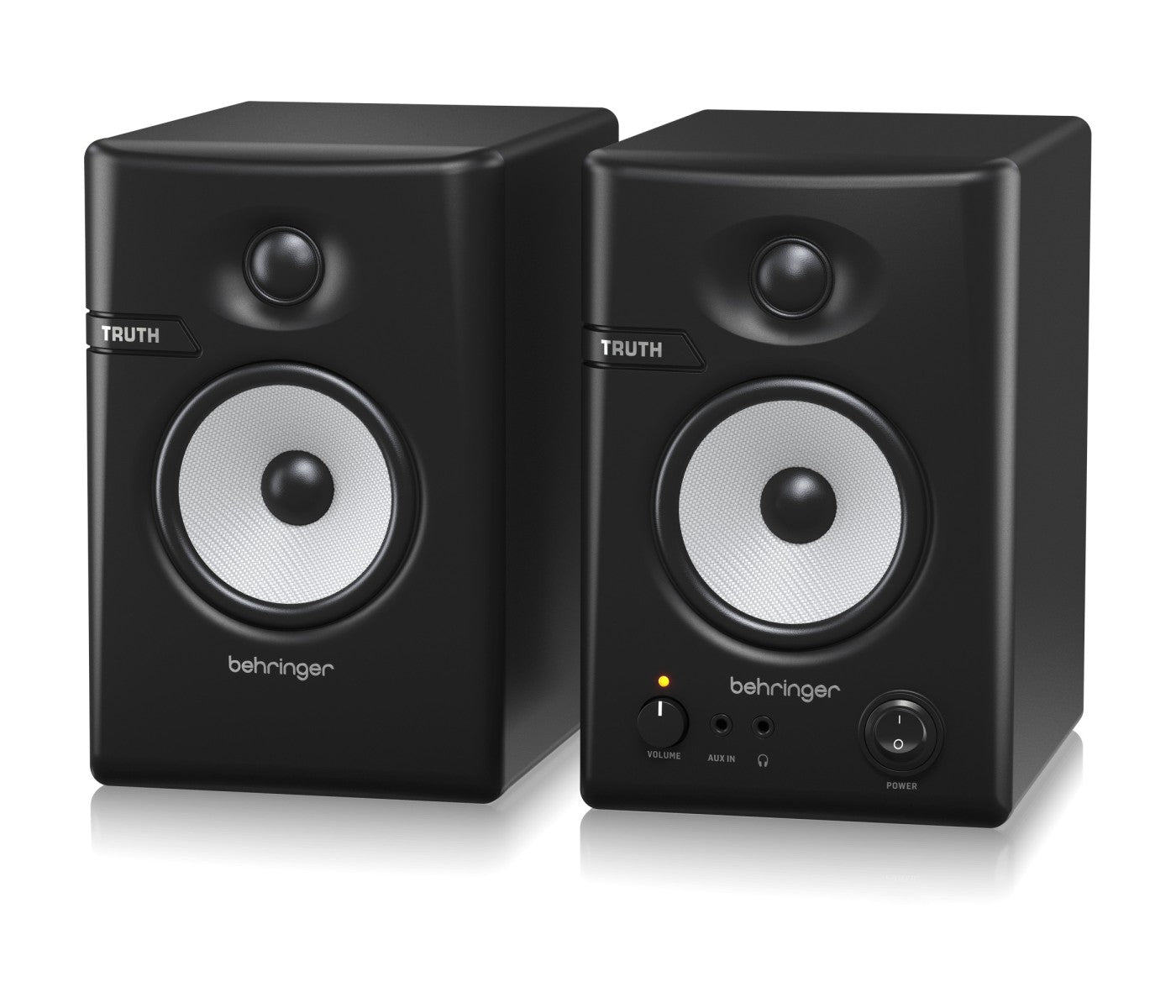 Pair of Behringer studio monitors on a white background