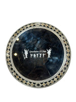 Decorative round object with intricate design and 'Gawharet El Fan' branding on a white background