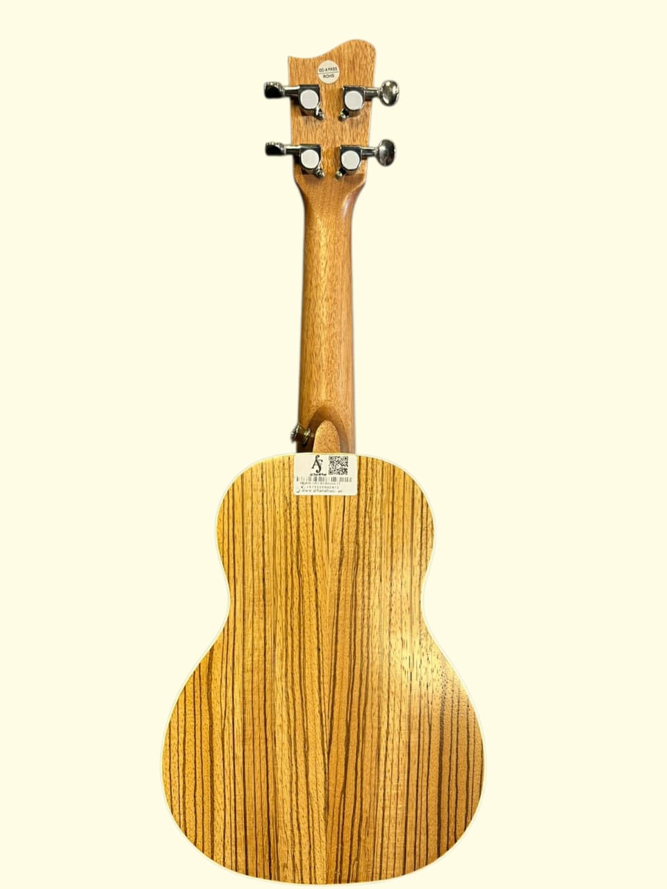 Wooden ukulele with a zebrawood pattern on a white background