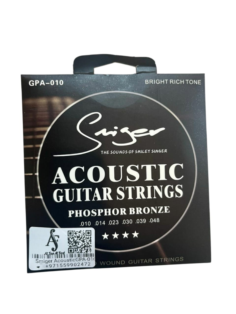 Pack of Singer acoustic guitar strings on a white background