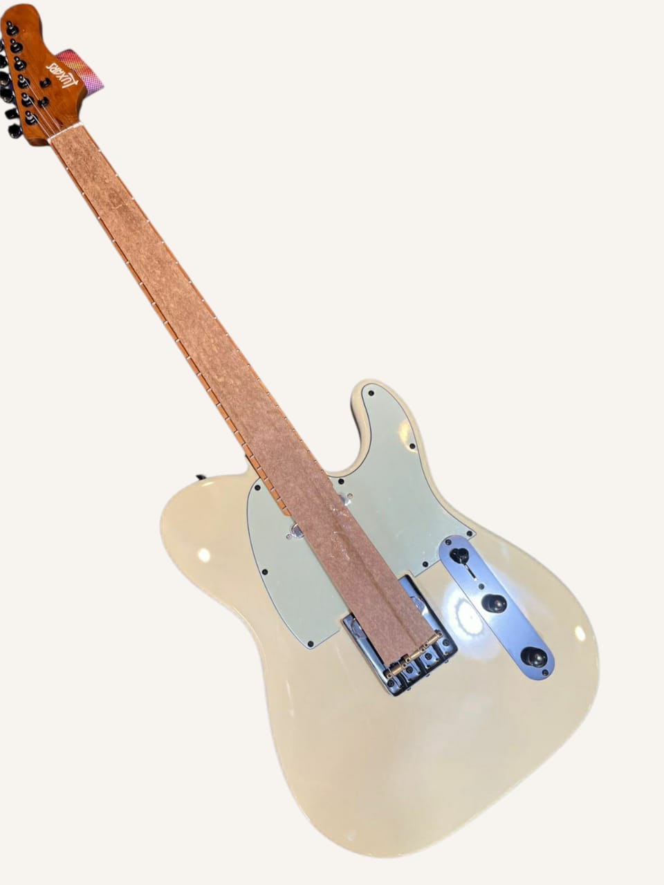 Electric guitar with a white pickguard on a white background