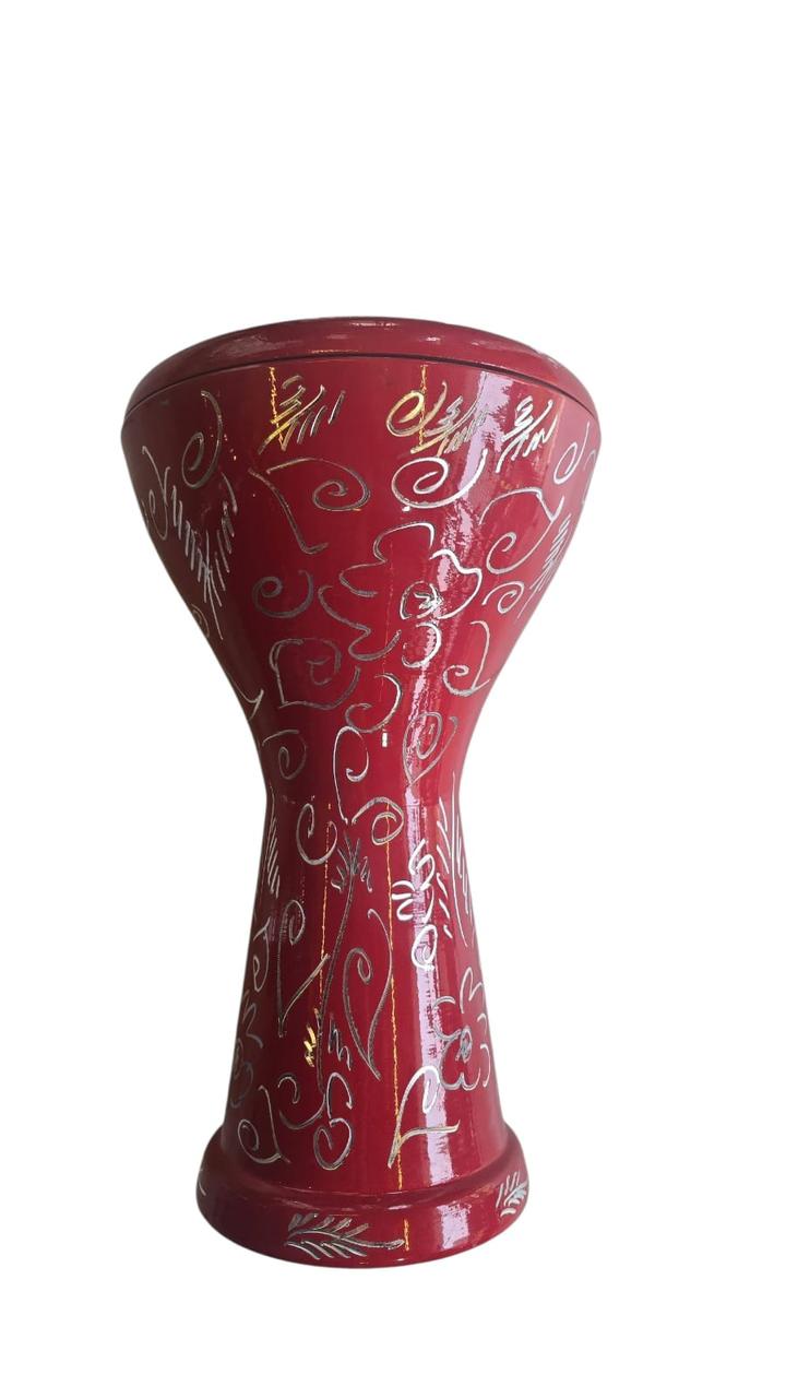 Red decorative vase with intricate patterns on a white background