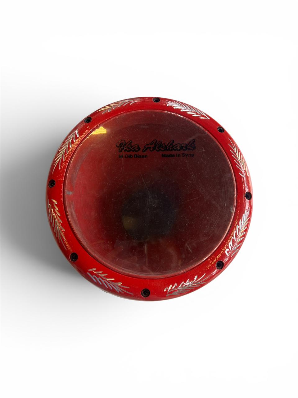 Red drum with black accents on a white background