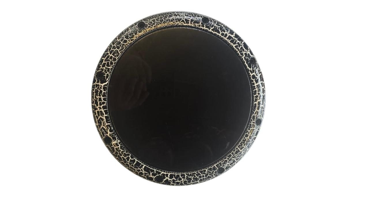 Round black plate with decorative rim on a white background