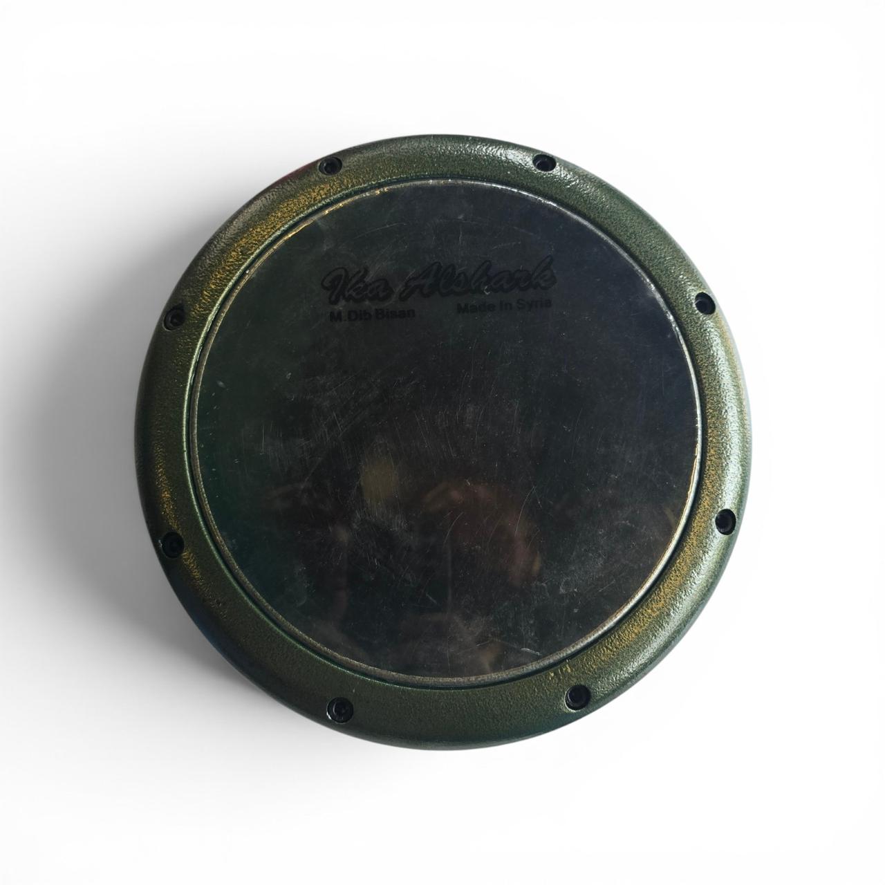 Round metal object with 'K&N' branding on a white background