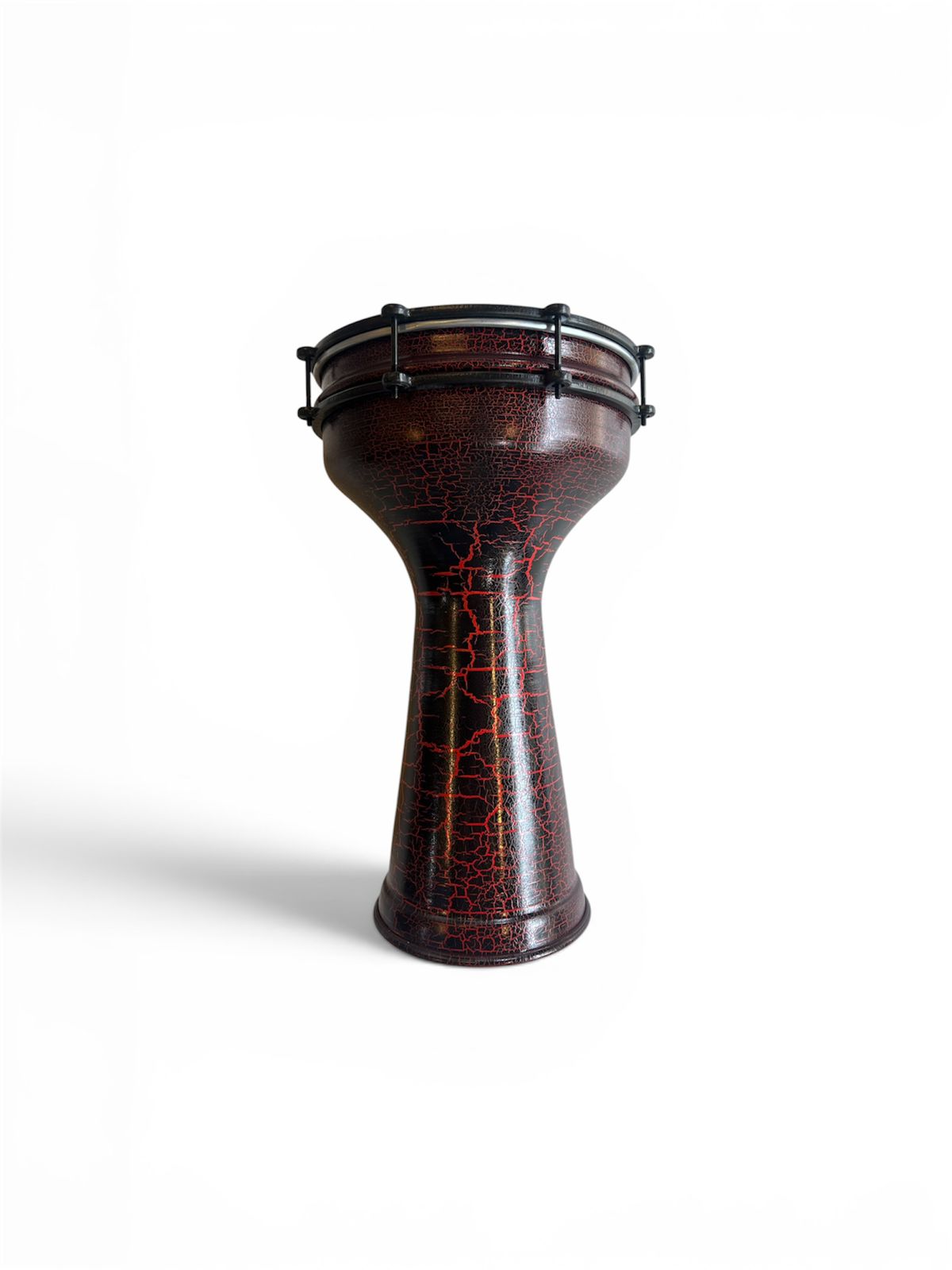Wooden drum with cracked red pattern on a white background