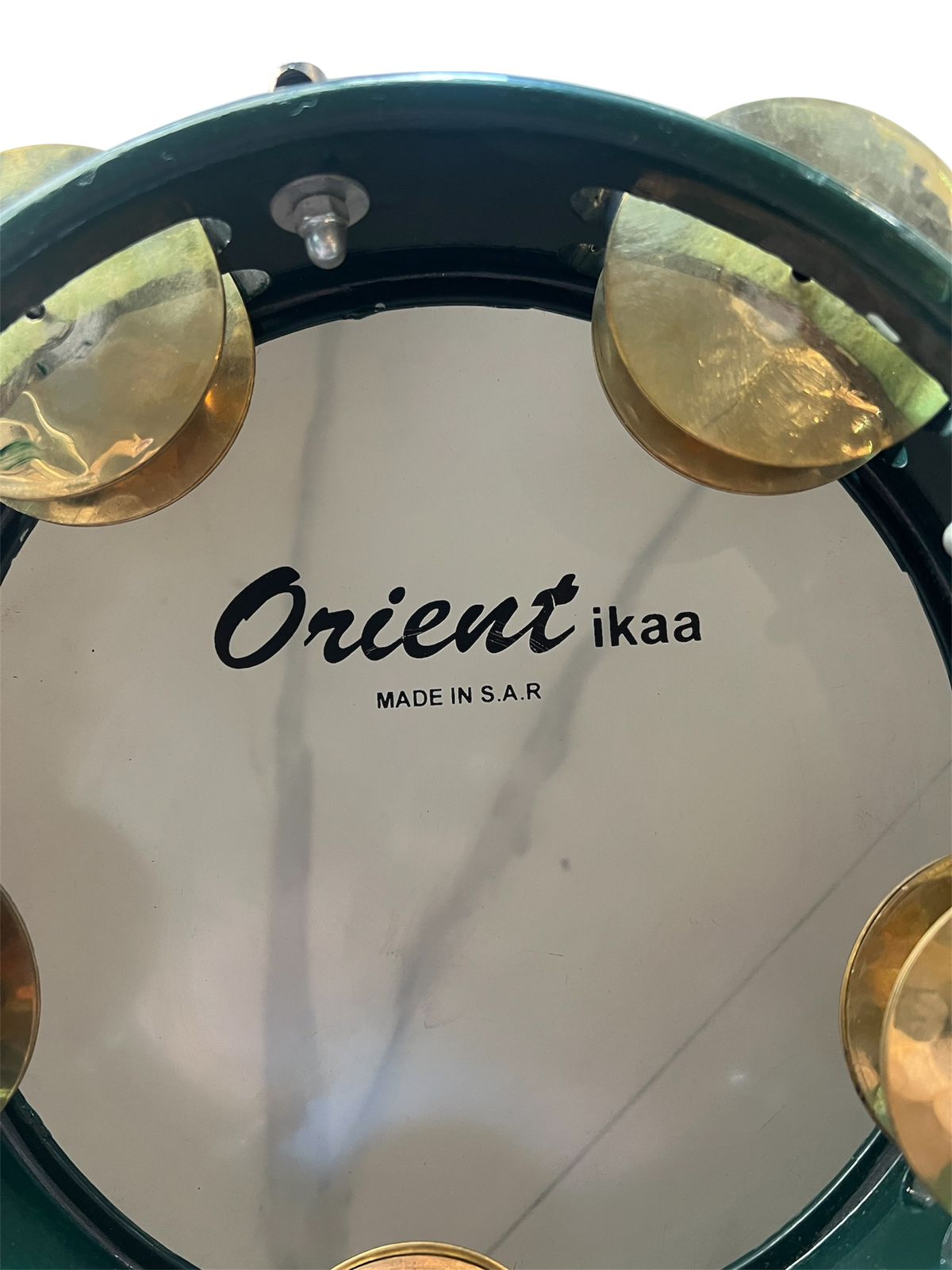 Close-up of a drum with 'Orient ikaa' branding on a white background