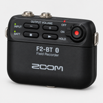 Close view of the Zoom F2-BT/B compact field recorder showing its buttons, screen area, and clip.