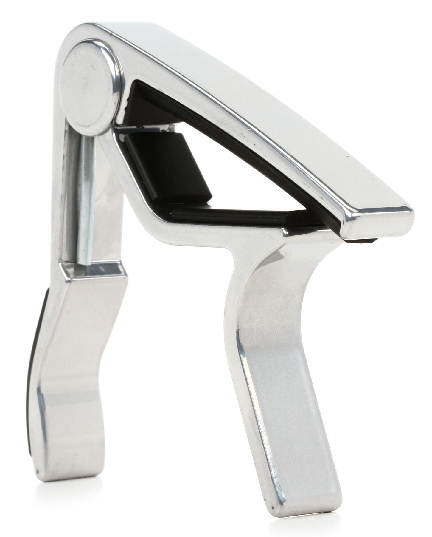 Metallic guitar capo on a white background