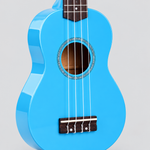 Close detail of the unbranded GK-10 blue soprano ukulele soundhole, bridge, four strings, and blue body finish