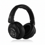 Behringer HPX6000 black professional DJ headphones shown from a three-quarter angle with Behringer branding, padded earcups, and folding headband