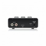 Behringer U-Phoria UM2 black USB audio interface shown from the rear with stereo RCA line outputs, USB port, power connection, and rear controls