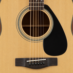 Close-up of the Yamaha FX310AII's soundhole, rosette, spruce top, strings and bridge.