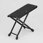 Unbranded J-46 foldable guitar footrest shown from a three-quarter angle with its textured platform, folding frame, and rubber feet