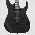 Straight-on close-up of the Ibanez GRG121DX humbuckers, strings, hardtail bridge, and controls.