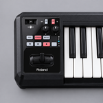 Close-up of the Roland A-49 BK control area with D-BEAM, knobs, switches, buttons, and pitch/modulation controller.