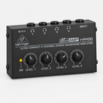 Angled view of the Behringer MicroAMP HA400 compact headphone amplifier with four output level controls.