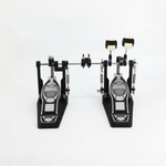 One Cymbal G710 double bass drum pedal unit shown from the front with both pedal boards, linkage, beaters, springs, and hardware