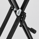 Close detail of the unbranded QA210 black double-X keyboard stand locking mechanism, adjustment lever, frame joints, and rubber support