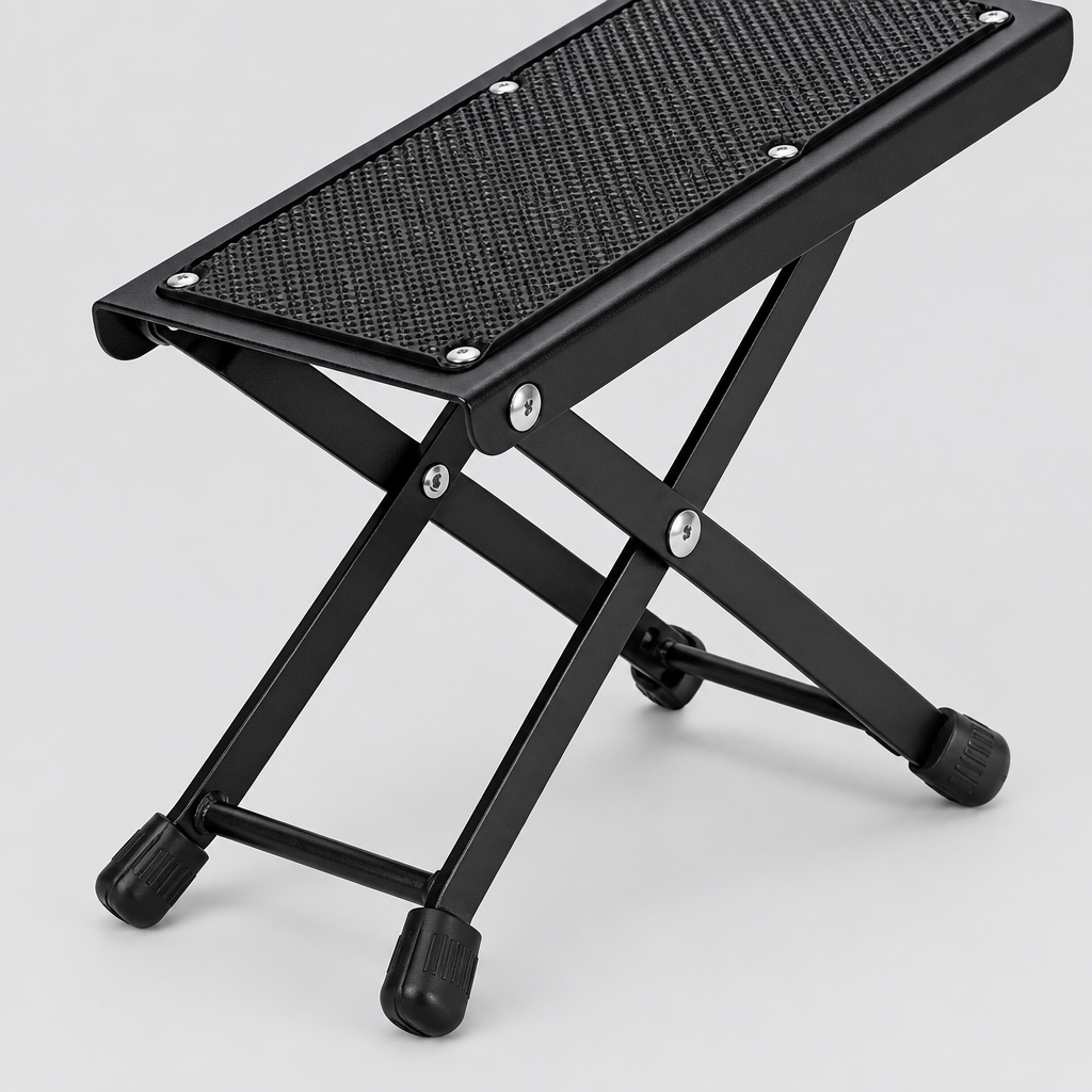 Close detail of the unbranded J-46 guitar footrest textured platform, folding hinge, support frame, and rubber foot