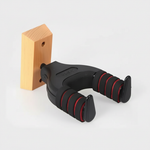 J-19A guitar hanger shown in a three-quarter view with its black padded arms, red accents, and mounting structure