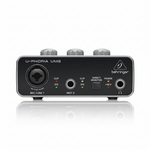 Behringer U-Phoria UM2 black USB audio interface shown from the front with XLR/TRS microphone input, instrument input, Direct Monitor switch, headphone output, and status lights