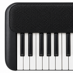 Close-up detail of the Yamaha PSR-F52 speaker grille and black-and-white keys.