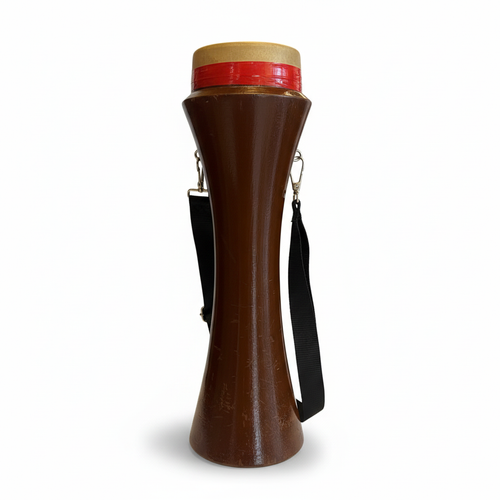 Kasoor traditional hand drum shown upright from the front with brown shaped body, red-accented top rim, and black shoulder strap on a white background